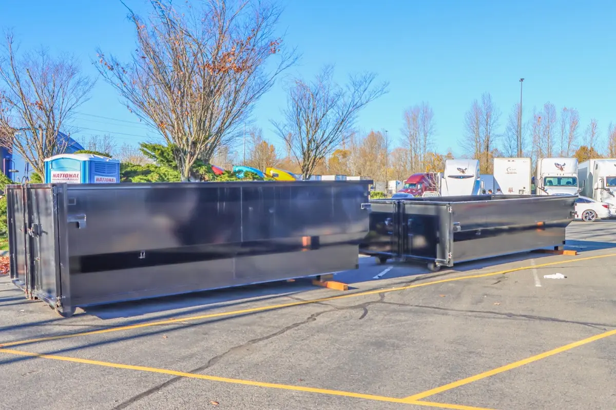 Professional dumpster rental service with roll-off container on residential driveway in Christiansburg